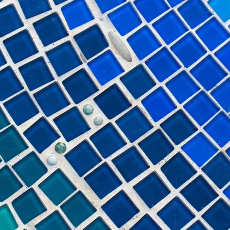 Close-up of blue mosaic swimming pool tiles
